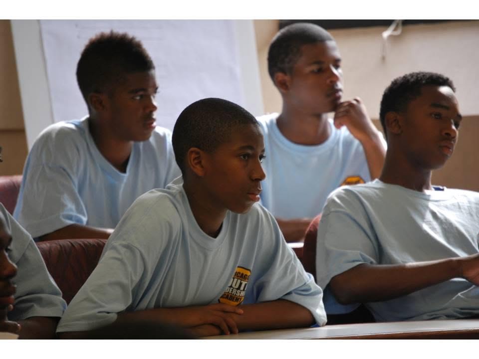 Young men engaged in a classroom learning session